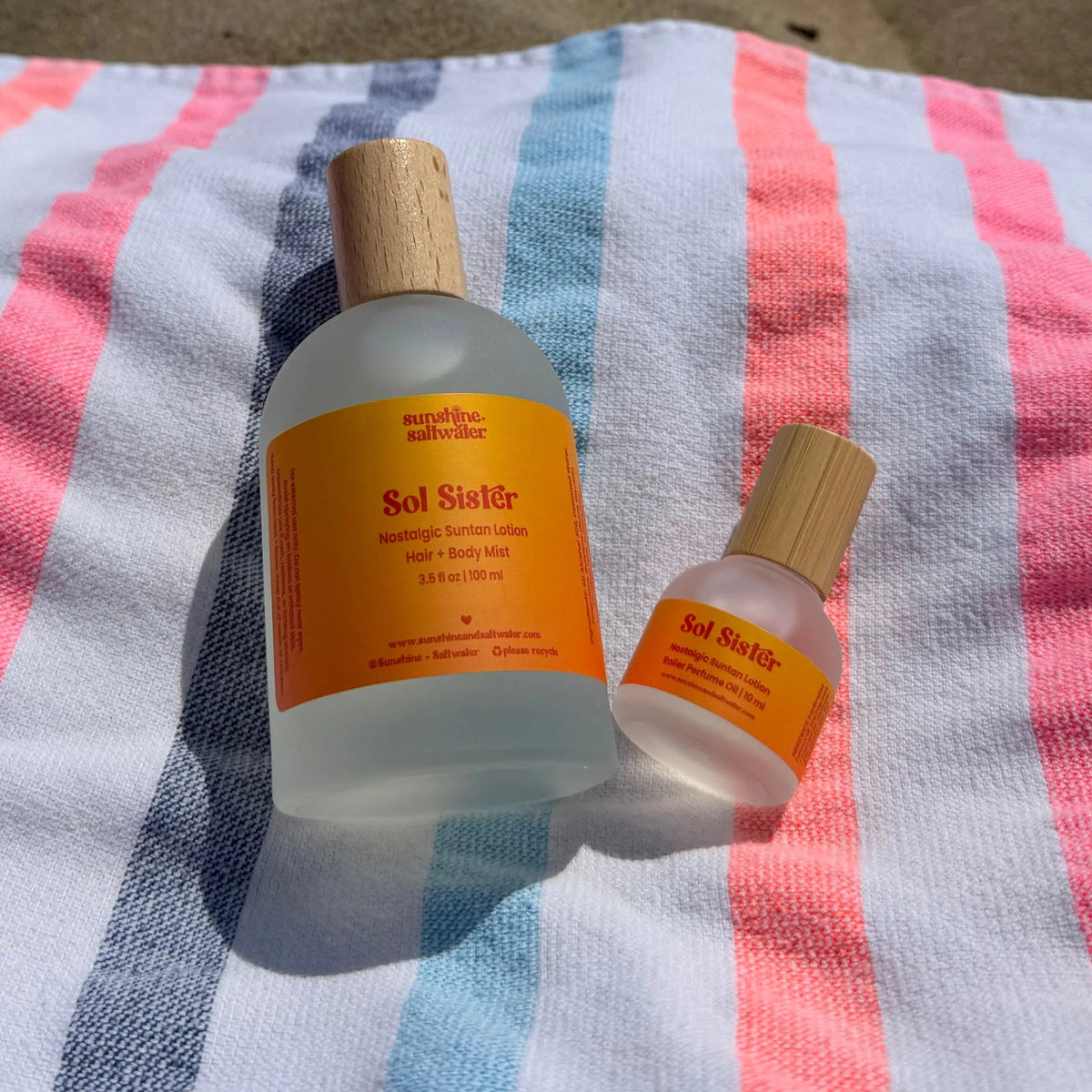 Sol Sister Body Mist and Rollerball on beach towel