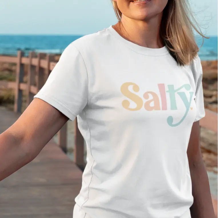model on beach wearing salty white t-shirt
